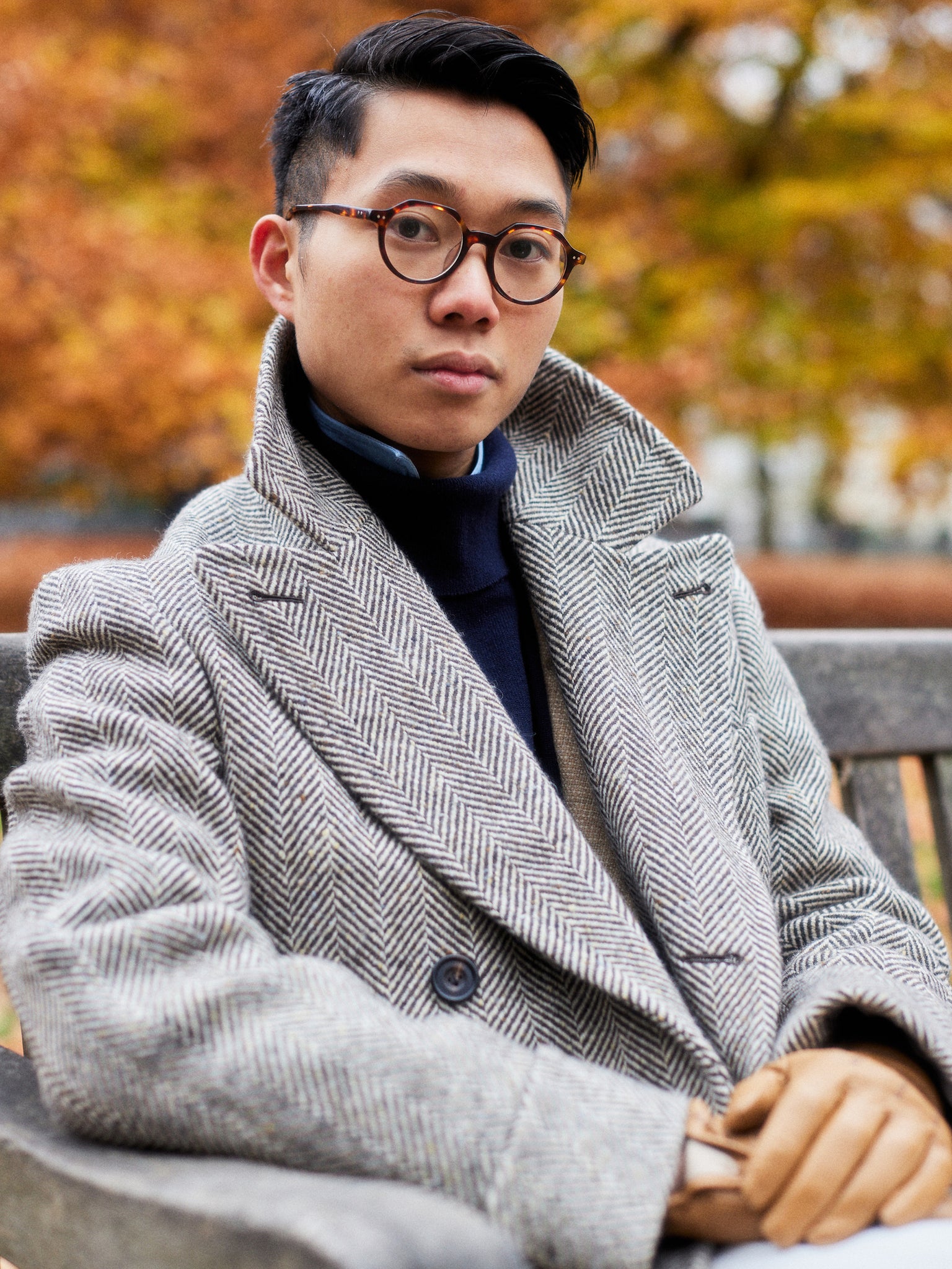 Buzz Tang wearing a grey coat that is a collaboration between his brand The Anthology and Permanent Style, interviewed by A Collected Man London