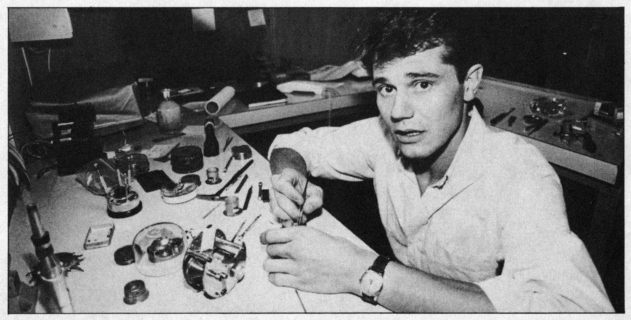 A black and white photo of a young F.P. Journe at his workbench working on a watch
