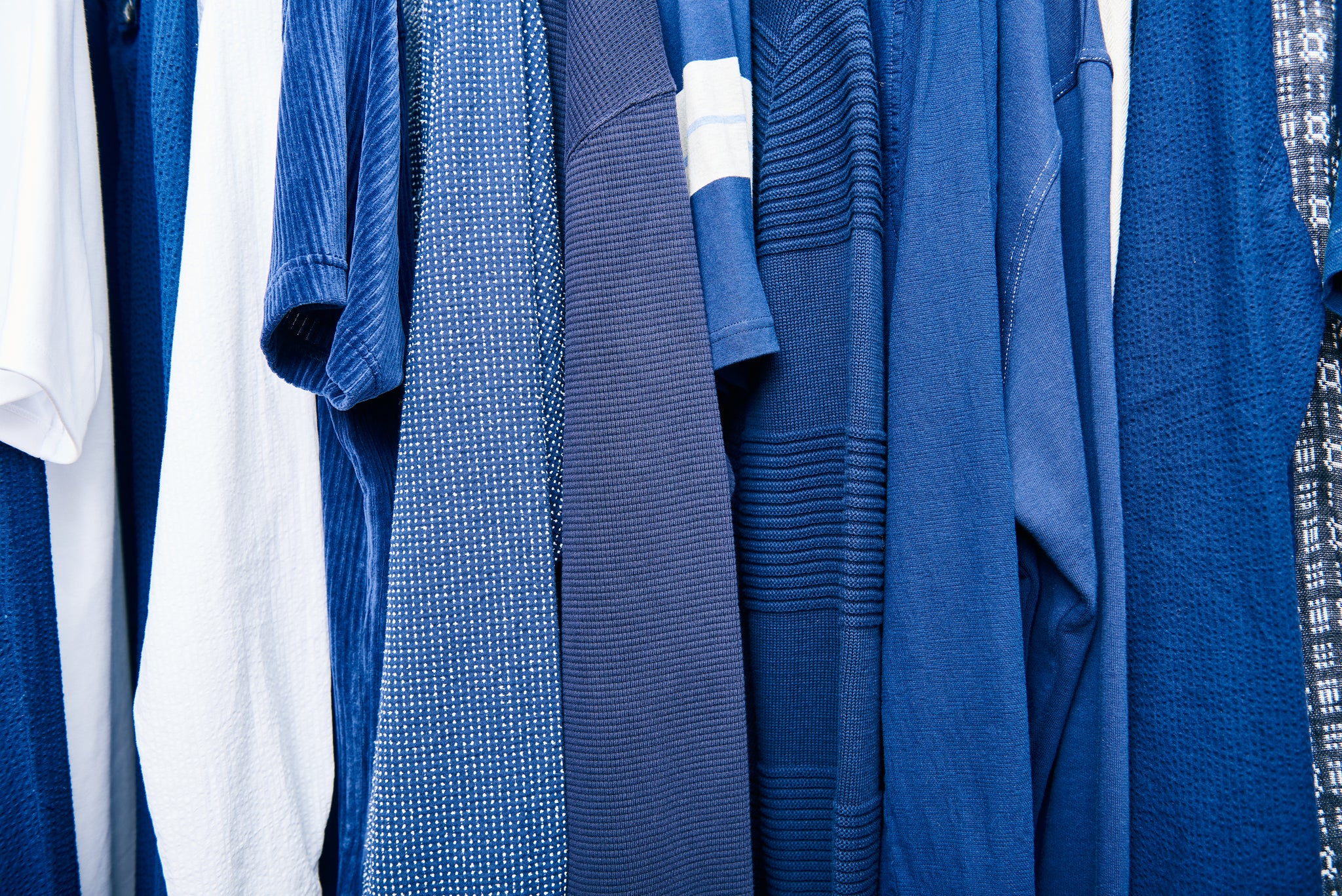 Blue shirts on a rack from Oliver Spencer with some white shirts as well interviewed by A Collected Man London