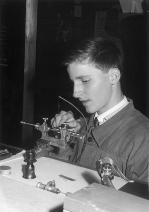 A very young Michel Parmigiani using a watchmaker’s bow lathe, courtesy of Parmigiani Fleurier.