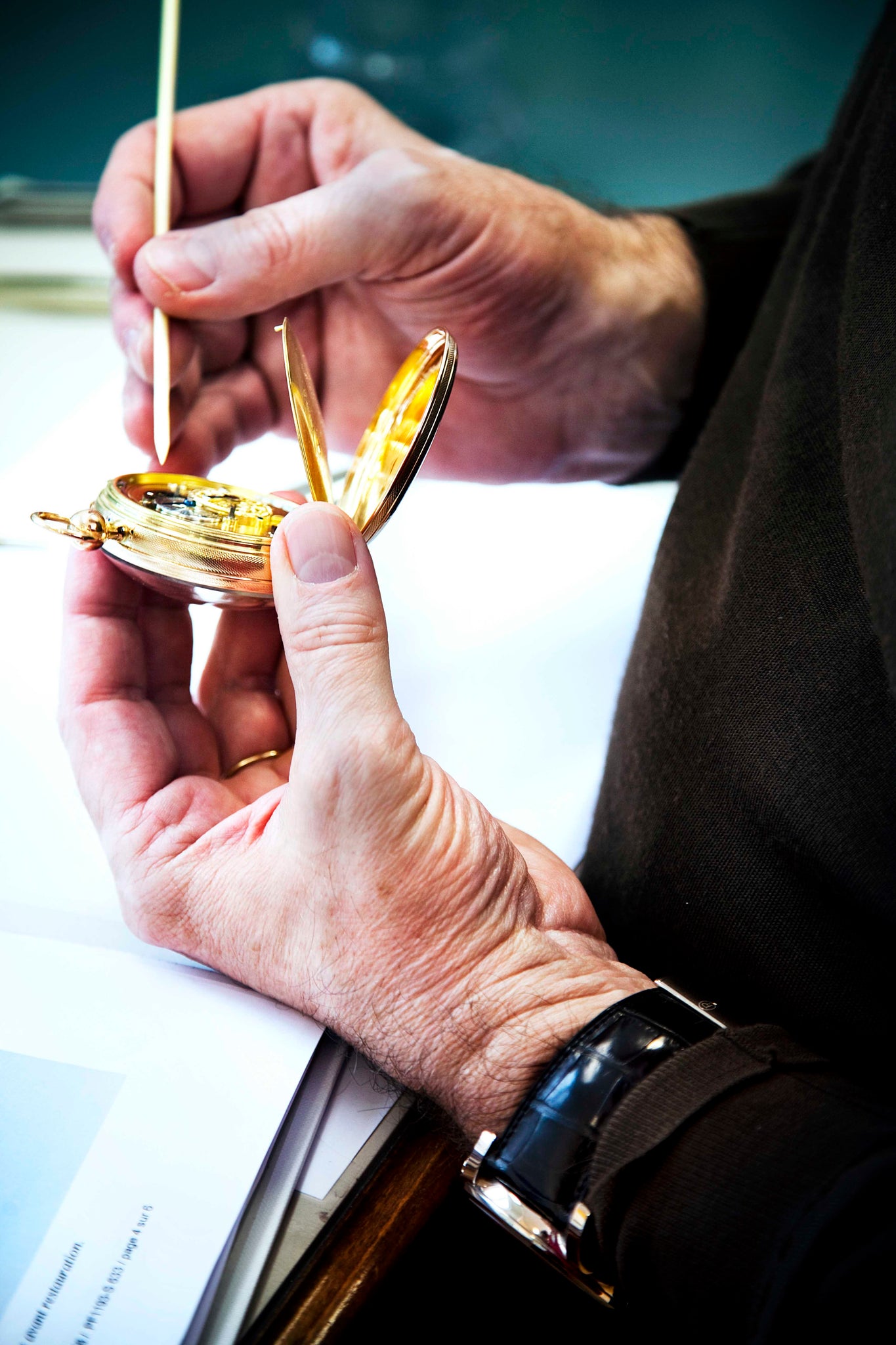 Parmigiani adjusting a pocket watch with a peg wood tool, courtesy of Parmigiani Fleurier.