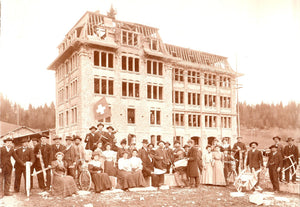 A brown-toned antique photo of the watchmaking school that Dufour attended, with a group of people posing for photographs outside it