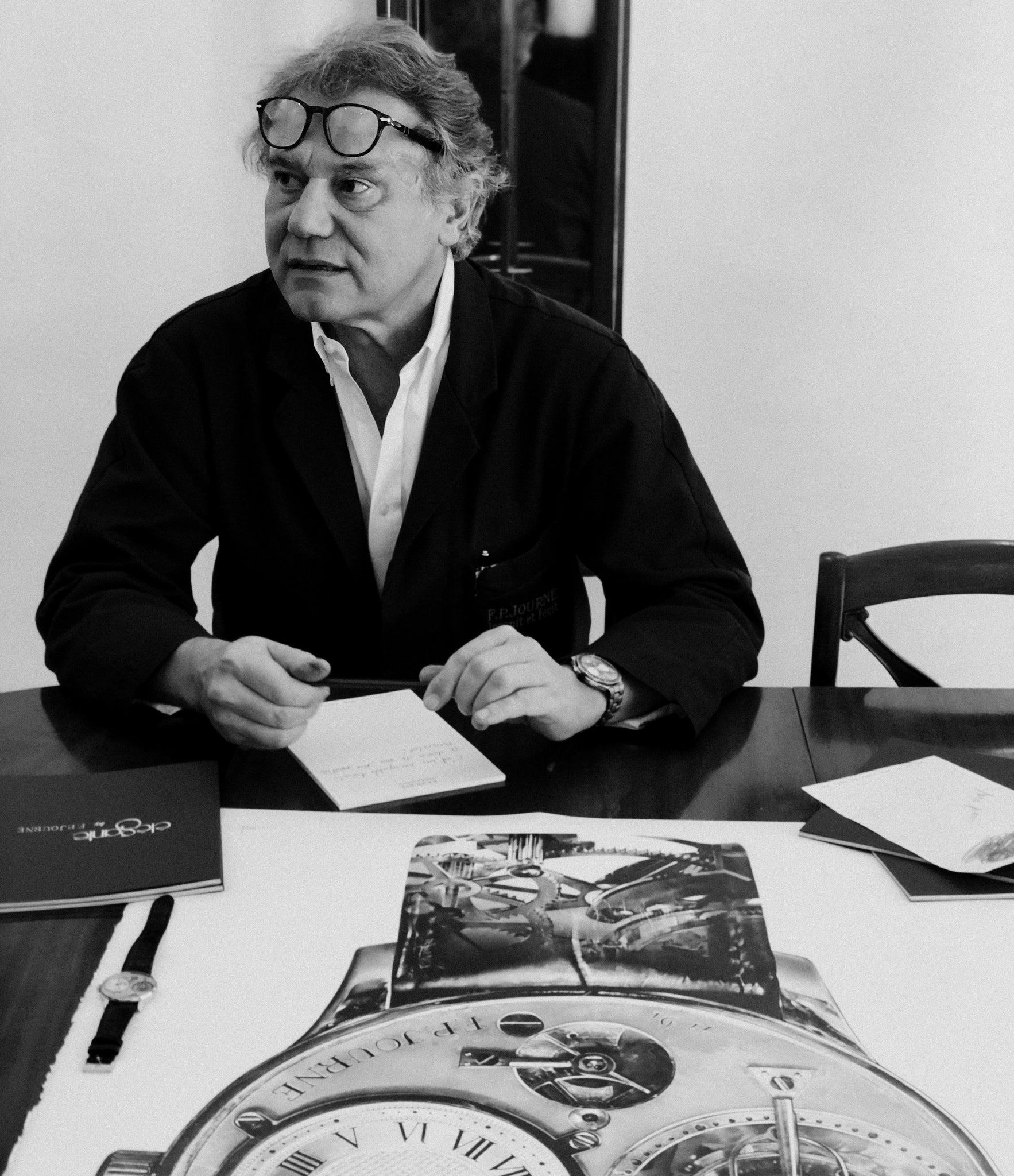 Monsieur Jracois Paul Journe signing the drawing of his first wristwatch the F. P. Journe Tourbillon drawing by Julie Kraulis auctioned by A Collected Man London to fund Covid-19 vaccine research 