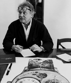 Monsieur Jracois Paul Journe signing the drawing of his first wristwatch the F. P. Journe Tourbillon drawing by Julie Kraulis auctioned by A Collected Man London to fund Covid-19 vaccine research 