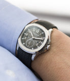buy Patek Philippe Aquanaut Travel-time 5164A-001 steel pre-owned traveller automatic wristwatch black dial dual time zone with box and papers for sale at WATCH XCHANGE London authenticity guaranteed